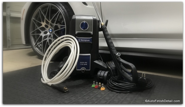 electric pressure washer for car detailing sitting in front of white BMW M4 electric pressure washer for car detailing