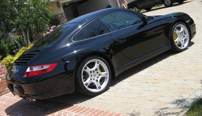 Porsche Carrera black sitting on driveway Porsche Carrera black